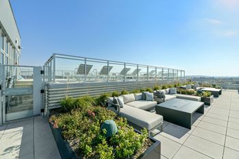 A terrace with couches and tables on a roof top